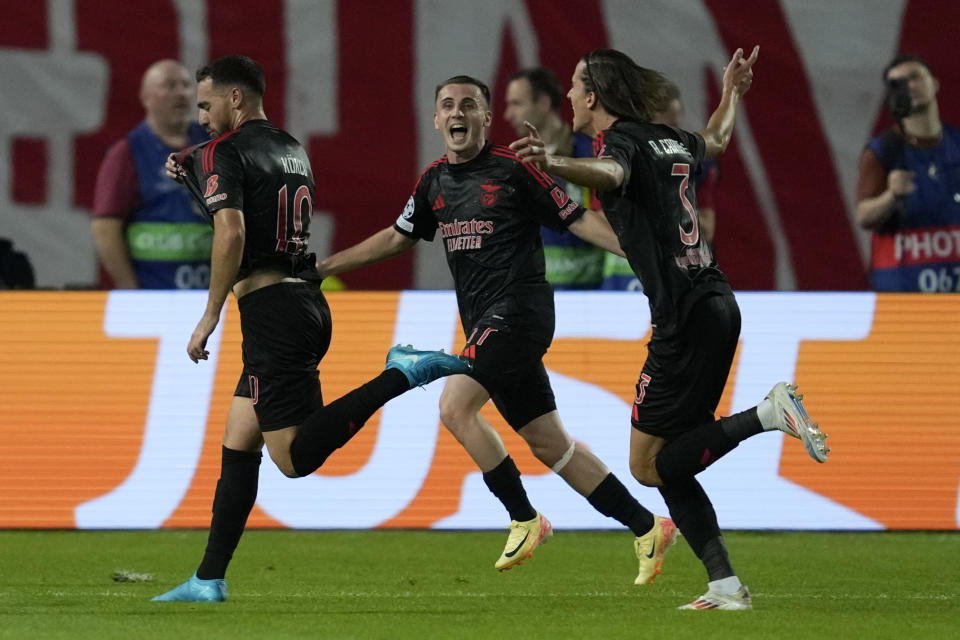 Benfica's Orkun Kokcu, left, celebrates with teammates after scoring his side's second goal during the Champions League opening phase soccer match between Red Star and SL Benfica, at the Rajko Mitic Stadium in Belgrade, Serbia, Thursday, Sept. 19, 2024. (AP Photo/Darko Vojinovic)