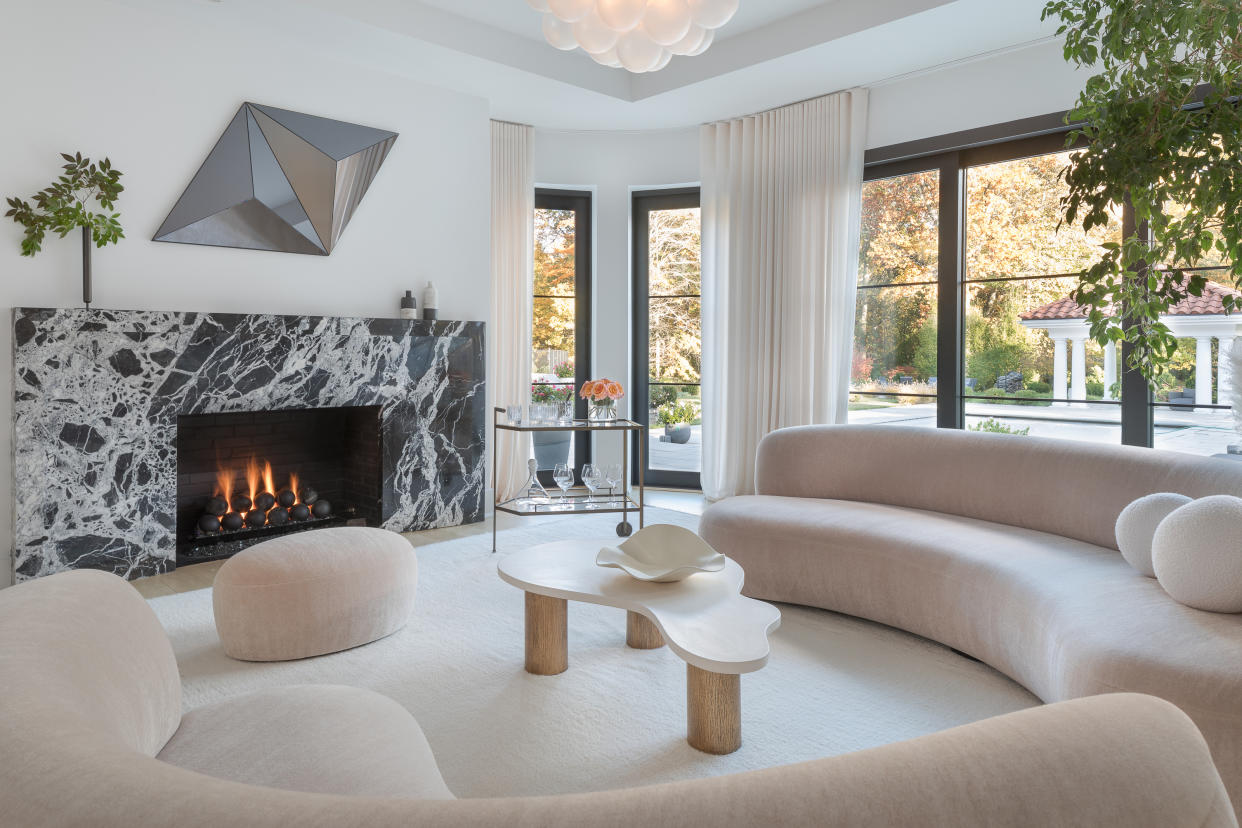  A living room with marble fireplace. 