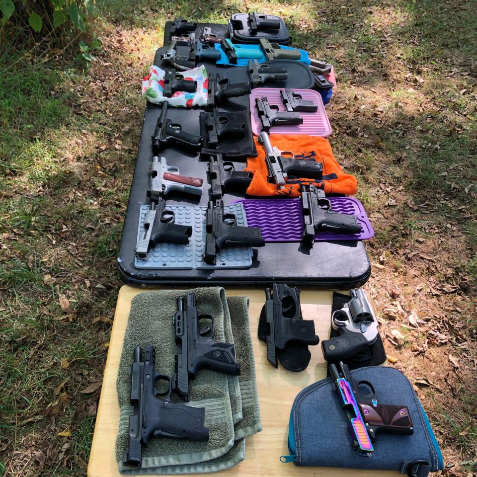 Ruger, Sig Sauer, Smith and Wesson. Handguns cover two tables as members of Armed Women of America prepare for target practice in September 2023 in Augusta County, Va.
