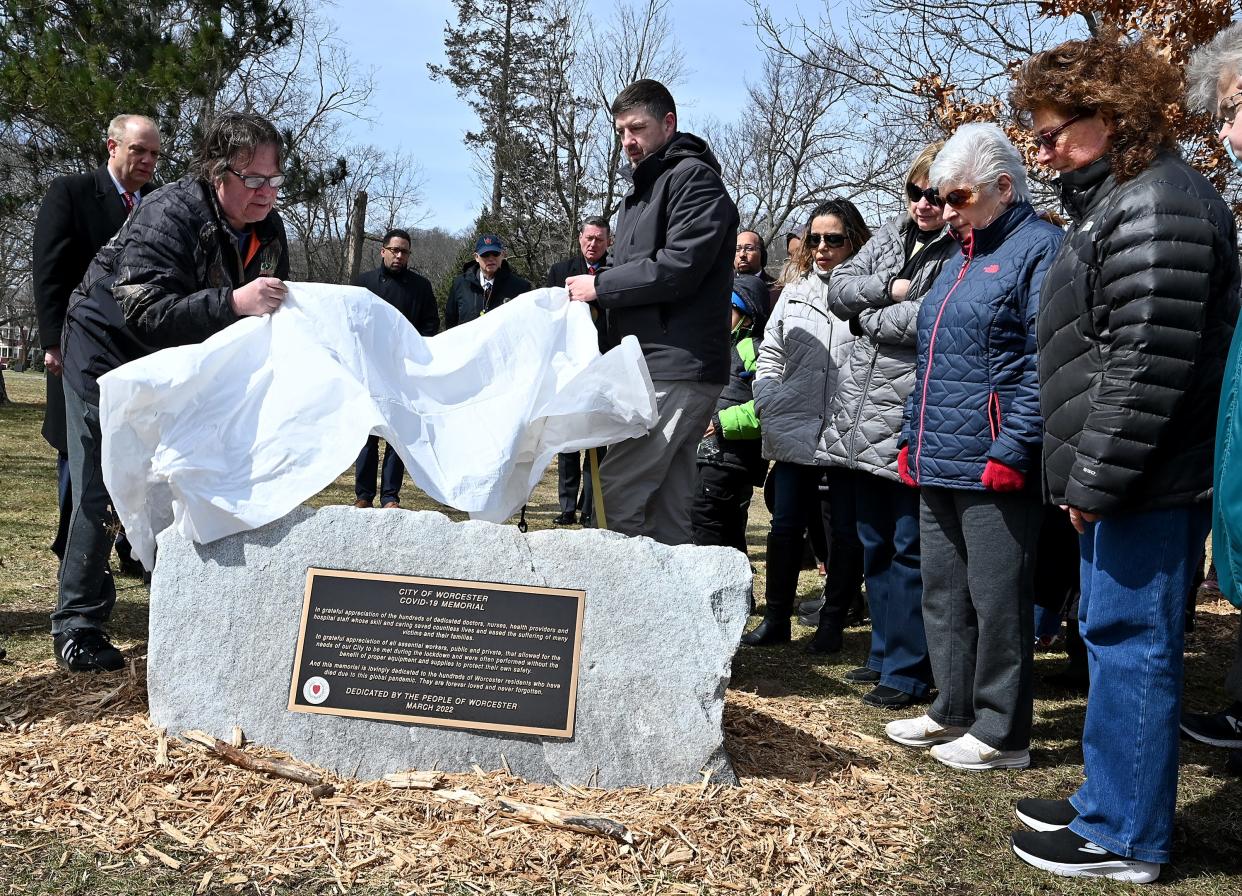 From right, Janet Willey, her mother, Alice Sahagian, Peggy Wilson and Rosa Hernandez watch as city leadership unveil a plaque to memorialize the lives of the 500 Worcester residents lost during the COVID-19 pandemic on March 29, 2022. Sahagian's husband, Harry Willey, Wilson's husband, Charlie Wilson, and Hernandez's son, Emilio Campos, all died due to COVID-19.