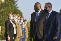 U.S. Defense Secretary Lloyd Austin, left, walks with Romanian Defense Minister Nicolae Ciuca during a welcoming ceremony in Bucharest, Romania, Wednesday, Oct. 20, 2021. Austin is visiting Romania before attending the NATO Defense Ministerial in Brussels. (AP Photo/Andreea Alexandru)
