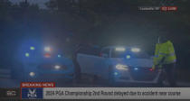 In this still image made from video provided by ESPN, Masters champion Scottie Scheffler is put into a police car after being handcuffed near Valhalla Golf Club, site of the PGA Championship golf tournament, early Friday, May 17, 2024. (ESPN via AP)