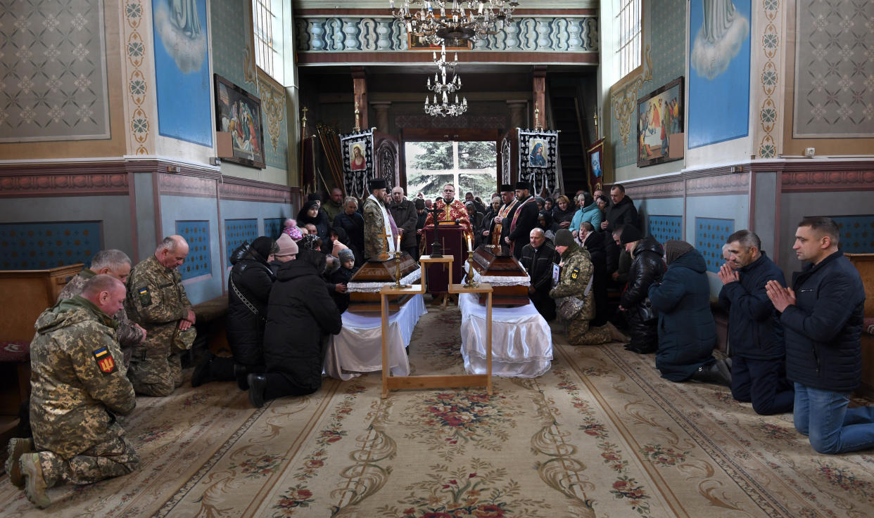 People attend a church service for for two fallen soldiers.