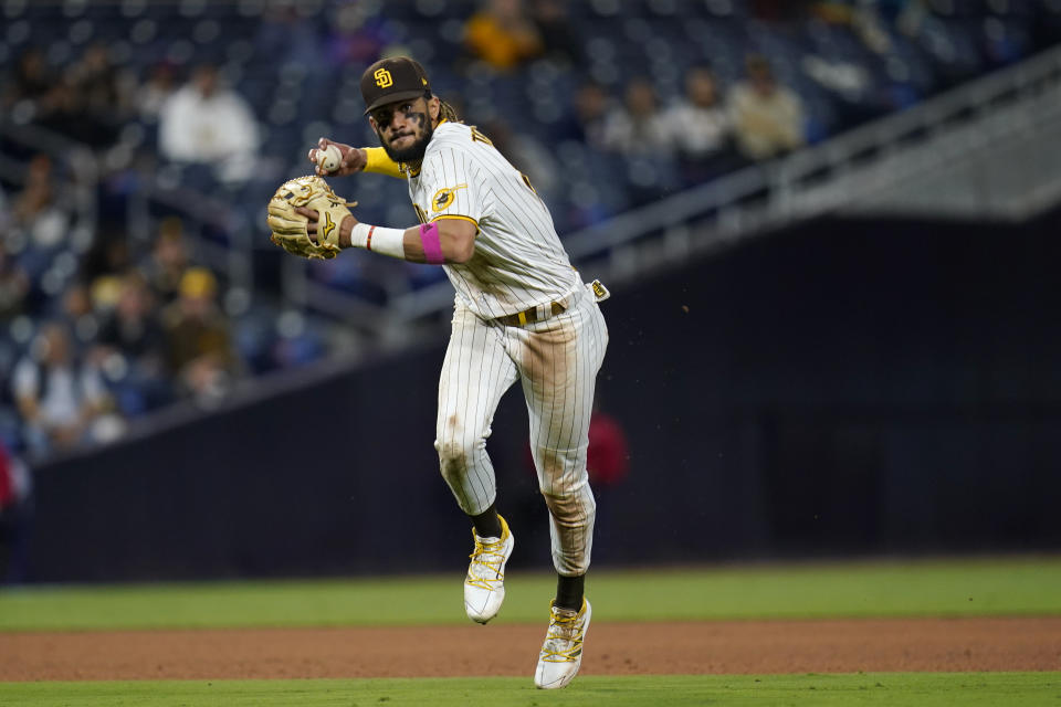 San Diego Padres shortstop Fernando Tatis Jr. throws to first for the out on New York Mets' Brandon Drury during the eighth inning of a baseball game Thursday, June 3, 2021, in San Diego. (AP Photo/Gregory Bull)