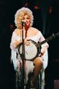 <p>Parton plays at The Dominion Theatre in London all dressed up in colorful, beaded fringe. By this time in 1983, Parton had extended her fanbase worldwide after collaborations with singers like Olivia Newton-John, Emmylou Harris, and Linda Ronstadt. However, her fame was cemented after starring alongside Jane Fonda and Lily Tomlin in "9 to 5."</p>