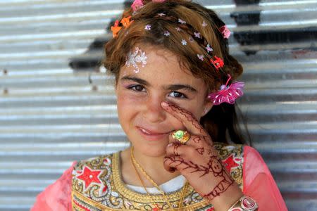 An iIraqi girl is seen as she celebrates Eid al-Fitr, in Mosul, Iraq June 25, 2017. REUTERS/Alaa Al-Marjani