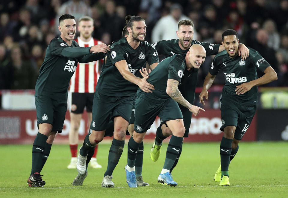 Newcastle United's Jonjo Shelvey, front centre, celebrates with teammates after scoring his side's second goal of the game against Sheffield United, during their English Premier League soccer match at Bramall Lane in Sheffield, England, Thursday Dec. 5, 2019. (Danny Lawson/PA via AP)