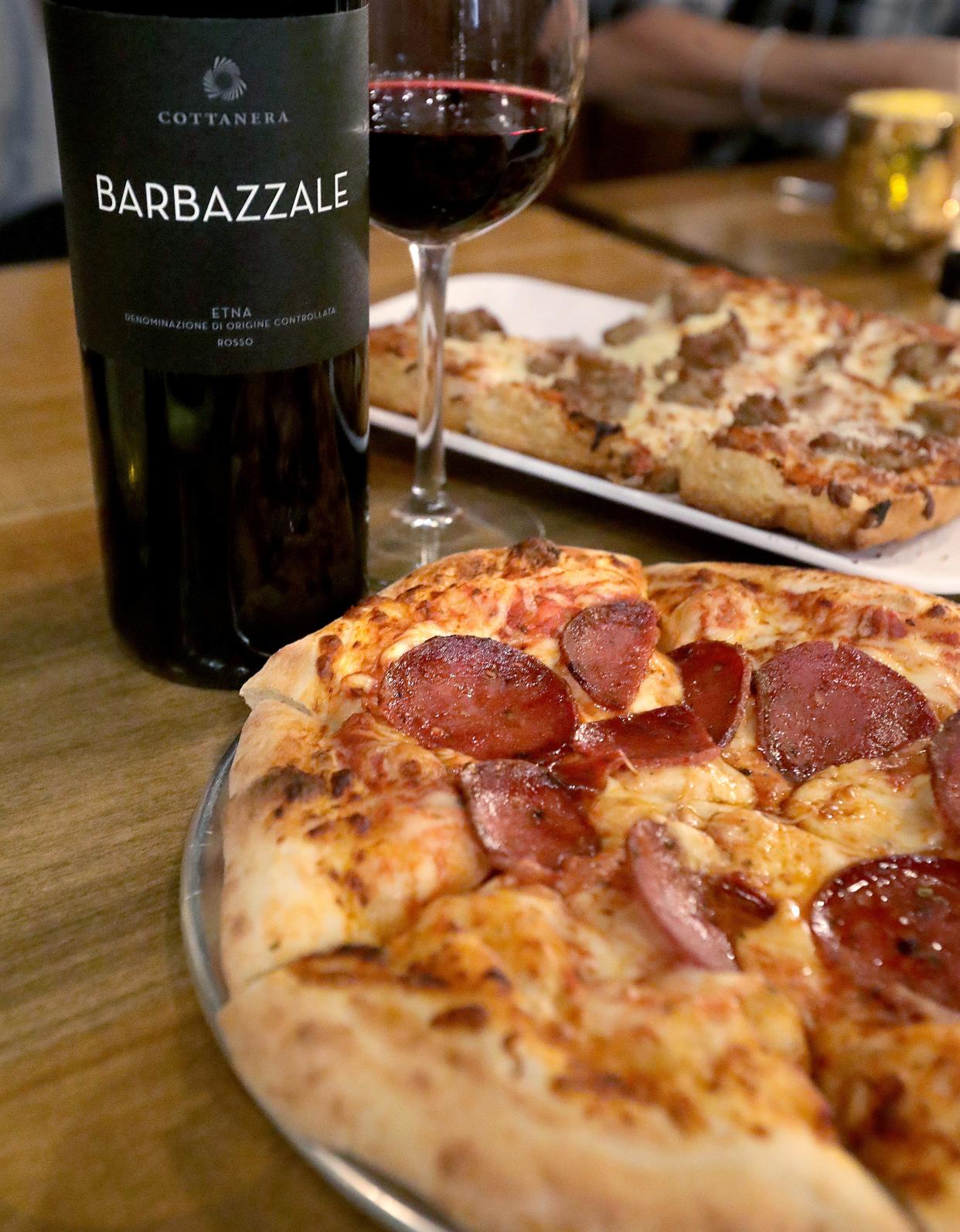 A bottle of Barbazzalle Etna Rosso and a Calabrese pizza from Cafe Arnone's Pizzeria & Wine Room in Fairlawn.