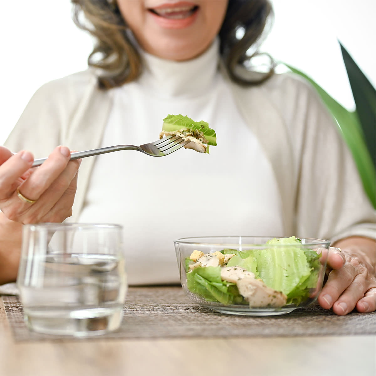 middle-aged-woman-smiling-eating-lunch