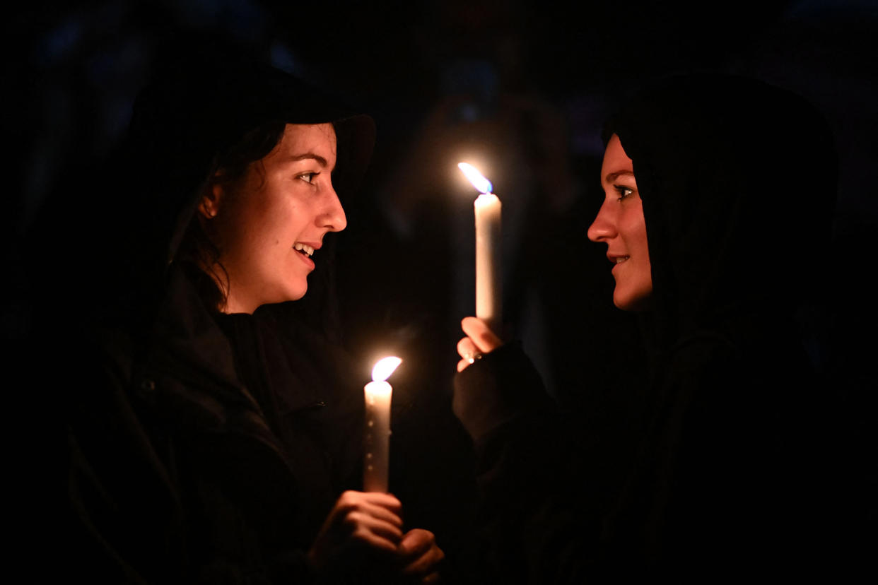 Image: Well-wishers leave candles outside Buckingham Palace, after the announcement of the death of Queen Elizabeth II on Thursday. (Ben Stansall / AFP - Getty Images)