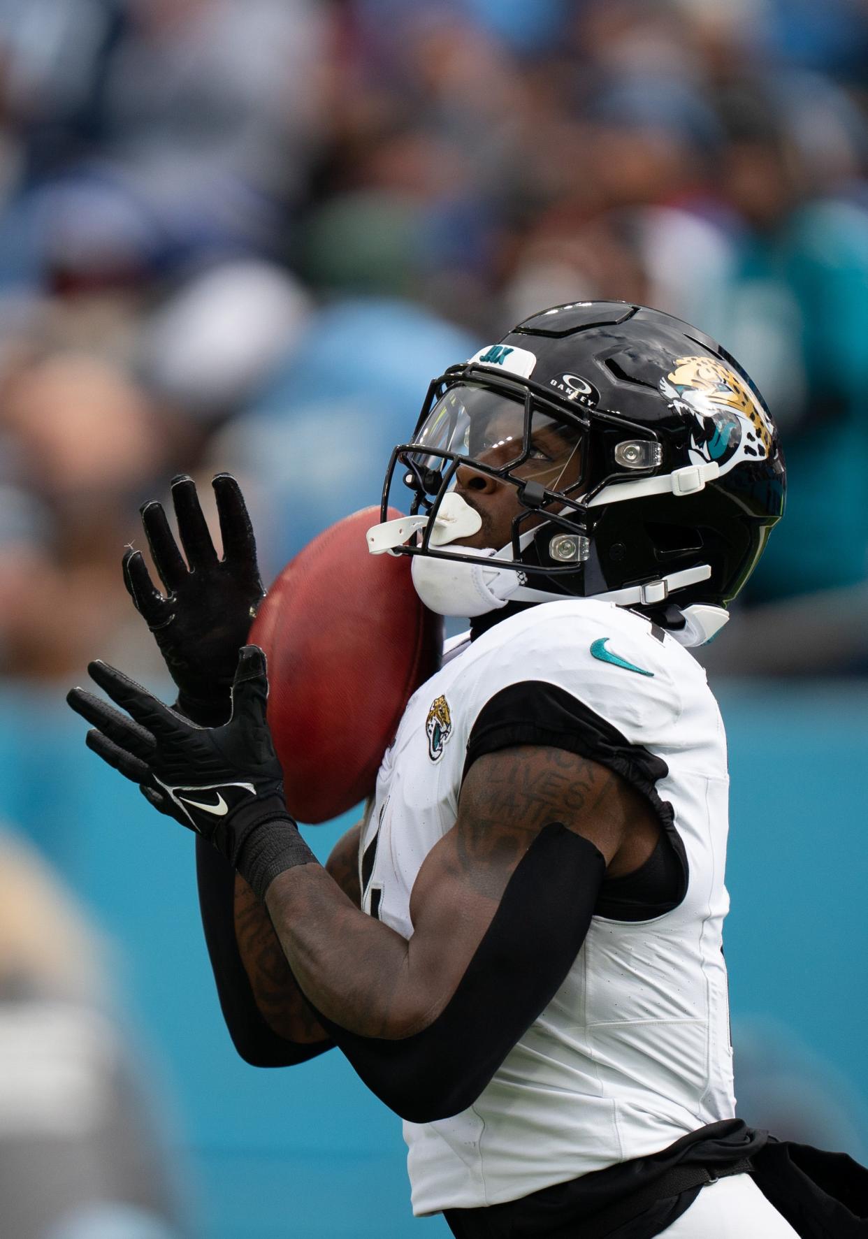 Jacksonville Jaguars running back Tank Bigsby fields a Tennessee Titans kickoff.