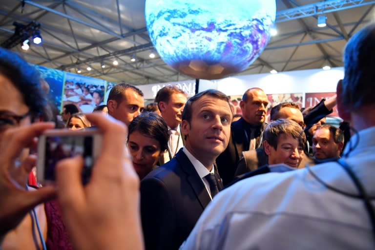 French President Emmanuel Macron (C) has invited heads of state and government, but not President Trump, as well as business leaders, to Paris on December 12 to discuss finance for climate projects