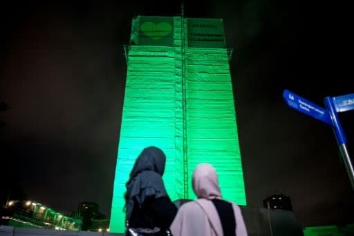 London's Grenfell Tower, where 71 people were killed in a fire a year ago, was illuminated in green