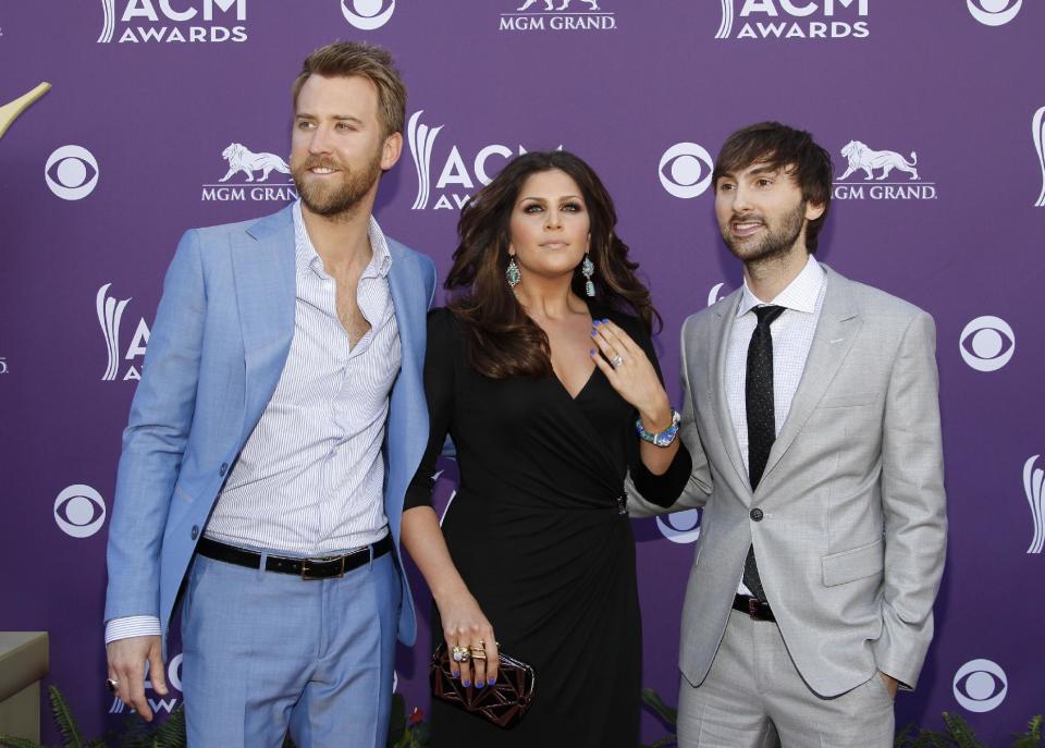 From left, Charles Kelley, Hillary Scott and Dave Haywood, of musical group Lady Antebellum, arrive at the 47th Annual Academy of Country Music Awards on Sunday, April 1, 2012 in Las Vegas. (AP Photo/Isaac Brekken)