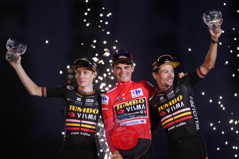 The winner Sepp Kuss of Jumbo-Visma, center, celebrates with teammates, second place Jonas Vingegaard, left, and third place Primoz Roglic on the podium after winning the 21st stage of the Vuelta cycling race between Hipodromo de La Zarzuela and Madrid, Spain, Sunday, Sept. 17, 2023. (AP Photo/Manu Fernandez)