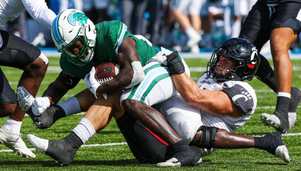 Tulane Green Wave running back Tyjae Spears is taken down by Cincinnati Bearcats linebacker Ty Van Fossen in the second half of their matchup last season. The Bearcats won, 31-12.