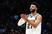 Denver Nuggets guard Jamal Murray gestures to teammates during the first quarter of the team's NBA basketball game against the Houston Rockets, Wednesday, Nov. 30, 2022, in Denver. (AP Photo/Jack Dempsey)