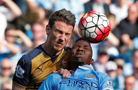 Britain Soccer Football - Manchester City v Arsenal - Barclays Premier League - Etihad Stadium - 8/5/16 Arsenal's Laurent Koscielny in action with Manchester City's Kelechi Iheanacho Reuters / Andrew Yates Livepic EDITORIAL USE ONLY.