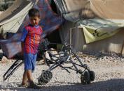 A Syrian refugee child who arrived with his family from Damascus, plays at the Majdal Anjar refugee camp in Bekaa Valley near the Syrian border in eastern Lebanon, September 9, 2013. REUTERS/Jamal Saidi