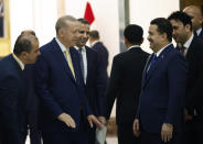 Turkish President Recep Tayyip Erdogan, second left and Iraqi Prime Minister Mohammed Shia al-Sudani, foreground right, react as they attend the signing of a four-way memorandum of understanding between Iraq, Turkey, Qatar and the UAE to cooperate in the Development Road project, in Baghdad, Iraq, Monday, April 22, 2024. Erdogan arrived in Iraq on Monday for his first official visit in more than a decade. (Thaier Al-Sudani/Pool Photo via AP)