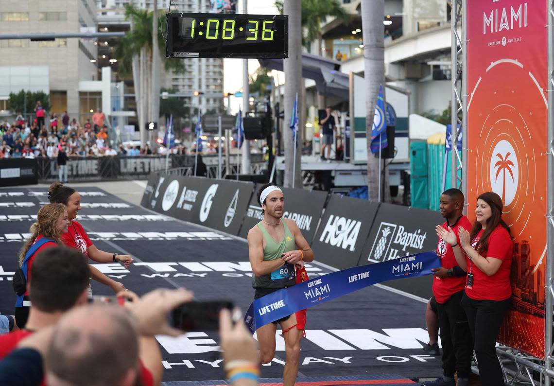 Life Time Half Miami Marathon men’s winner Nacho Hernando Angulo, 29, of United States, crosses the finish line after completing the race on Sunday, Jan. 29, 2023, in Miami Fla.