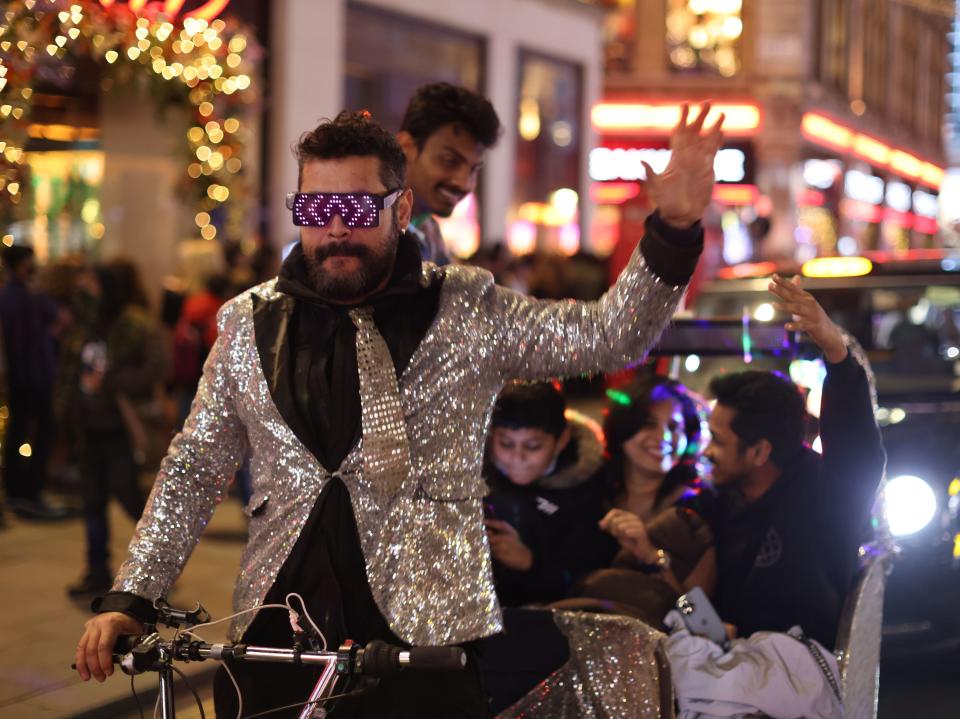 A tricycle taxi rides through central London ahead of New Year’s Eve celebrations (James Manning/PA)