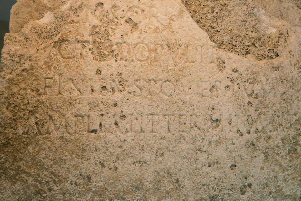 A detail of an archeological finding emerged during the excavations at a Mausoleum is pictured during its presentation to the press in Rome, Friday, July 16, 2021. The monumental pomerial stone is dating back to Roman Emperor Claudio and was used to mark the ‘pomerium’ the sacred boundaries of the ‘Urbe’, the city of Rome, during the Roman empire. (AP Photo/Domenico Stinellis)