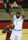 Los Angeles Lakers forward Anthony Davis (3) dunks over Houston Rockets forward P.J. Tucker (17) during the first quarter of an NBA basketball game on Sunday, Jan. 10, 2021, at Toyota Center in Houston. (Brett Coomer/Houston Chronicle via AP)