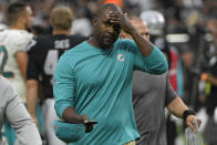 Miami Dolphins head coach Brian Flores walks off the field after losing to the Las Vegas Raiders in overtime of an NFL football game, Sunday, Sept. 26, 2021, in Las Vegas. (AP Photo/David Becker)