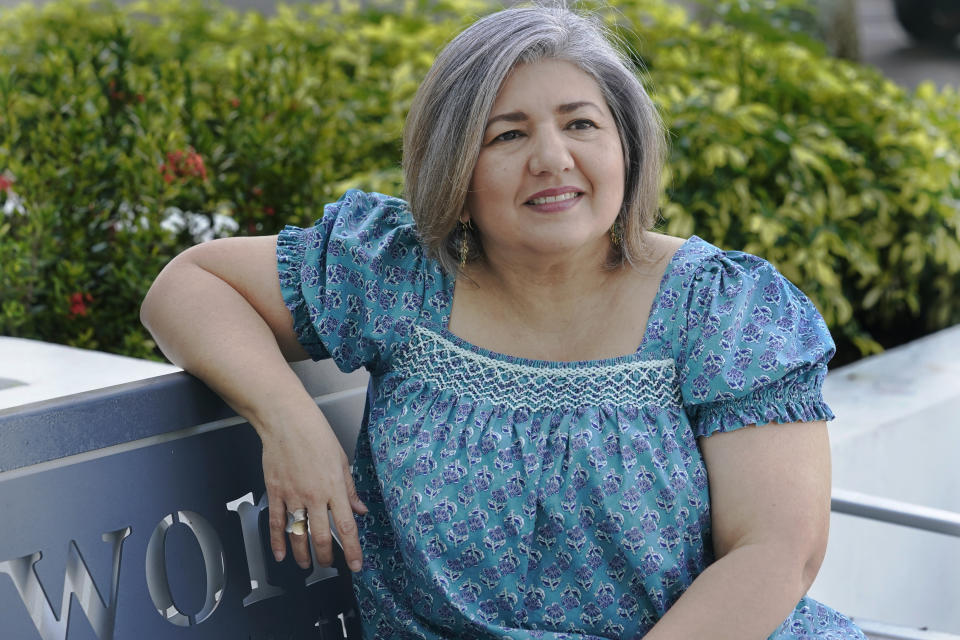 Maria Antonieta Diaz poses for a photo, Thursday, Jan. 5, 2023, in Miramar, Fla. Diaz has sponsored several Venezuelans under a parole program started in October. The Biden administration announced an expansion of that program to Cubans, Nicaraguans and Haitians seeking to enter the U.S. (AP Photo/Marta Lavandier)