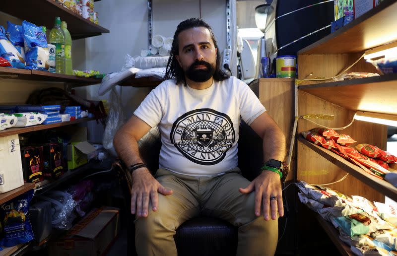 Sami Masri, a 38-year-old businessman from the south, attends an interview with Reuters at his coffeeshop in Hamra