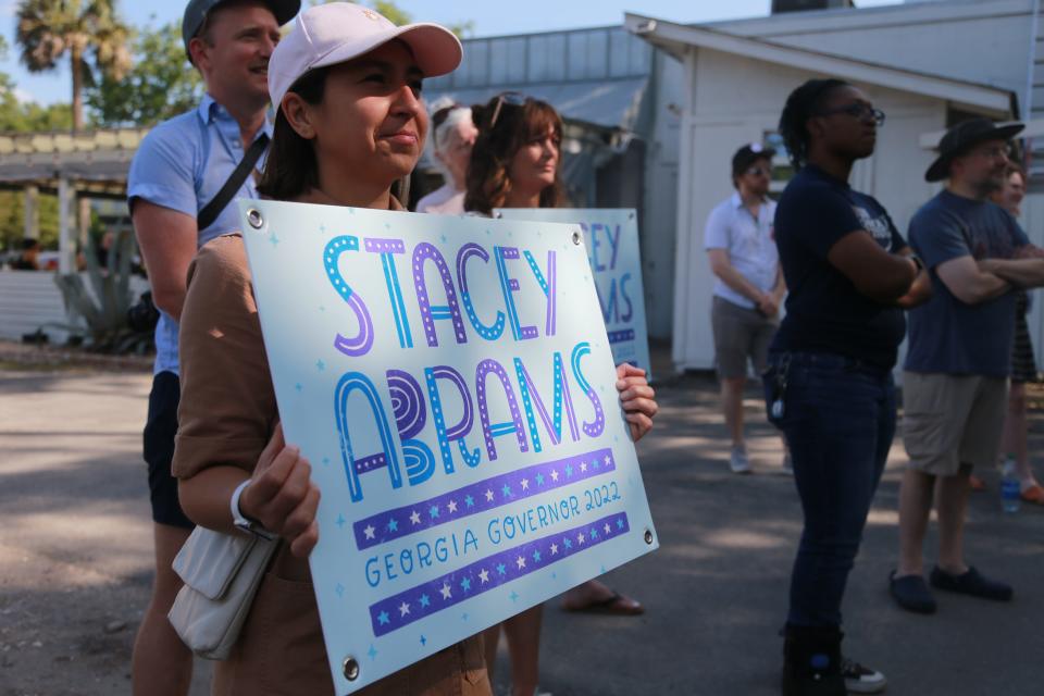 Supporters hold signs during a campaign rally for Democrat candidate for Governor Stacey Abrams.