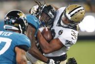 Aug 9, 2018; Jacksonville, FL, USA; New Orleans Saints running back Jonathan Williams (32) is hit by Jacksonville Jaguars defensive back Jarrod Wilson (26) after a catch during the second half at TIAA Bank Field. Reinhold Matay-USA TODAY Sports