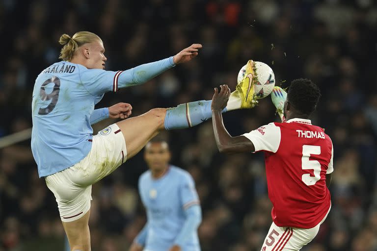 Erling Haaland y Thomas Partey disputan la pelota en un encuentro por la FA Cup