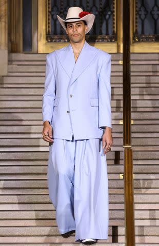 <p>JP Yim/Getty</p> Bad Bunny's sibling Bernie Marti­nez Ocasio walks the runway at the Willy Chavarria fashion show during New York Fashion Week in September 2023.