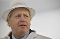 Britain's Prime Minister and Conservative Party leader Boris Johnson, center, visits Grimsby fish market in Grimsby, northeast England, Monday Dec. 9, 2019, ahead of the general election on Dec. 12. All 650 seats in the House of Commons are up for grabs Thursday when voters will pass judgement on a divisive election that will determine Britain's future with European Union. (Ben Stansall/Pool via AP)