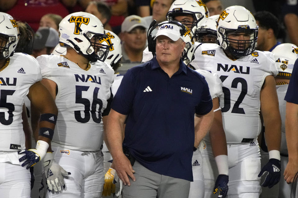 Northern Arizona coach Chris Ball watches a replay during the first half of the team's NCAA college football game against Arizona, Saturday, Sept. 2, 2023, in Tucson, Ariz. (AP Photo/Rick Scuteri)