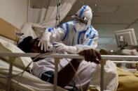 Medical workers treat patients infected with the coronavirus disease (COVID-19) at a hospital in New Delhi