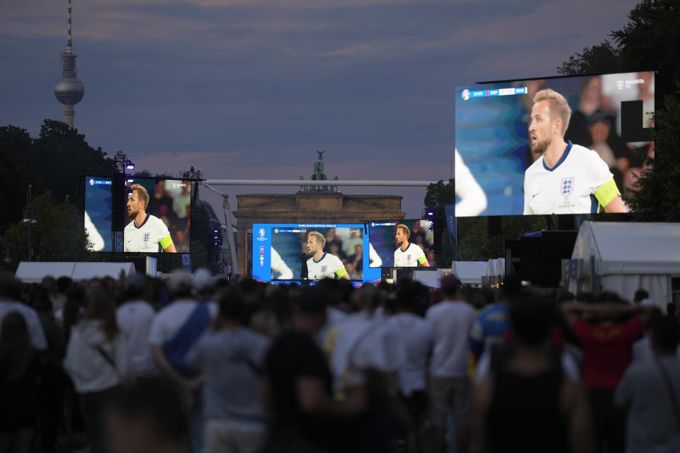 England's Harry Kane is shown on a screen at a fan zone during the final match between Spain and England at the Euro 2024 soccer tournament in Berlin, Germany, Sunday, July 14, 2024. (AP Photo/Markus Schreiber)