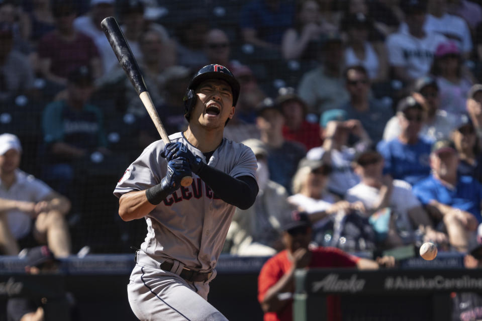 Cleveland Guardians' Steven Kwan reacts after fouling a ball off his leg during the eighth inning of a baseball game against the Seattle Mariners, Thursday, Aug. 25, 2022, in Seattle. (AP Photo/Stephen Brashear)