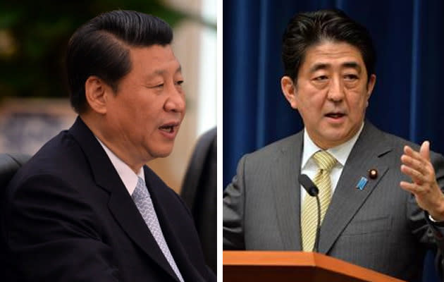 Chinese President Xi Jinping and Japanese Prime Minister Shinzo Abe were named "Asians of the Year" for 2013 on Wednesday by Singapore’s Straits Times, which urged them to reach out to each other to avert a conflict. (Getty Images and AFP photo)