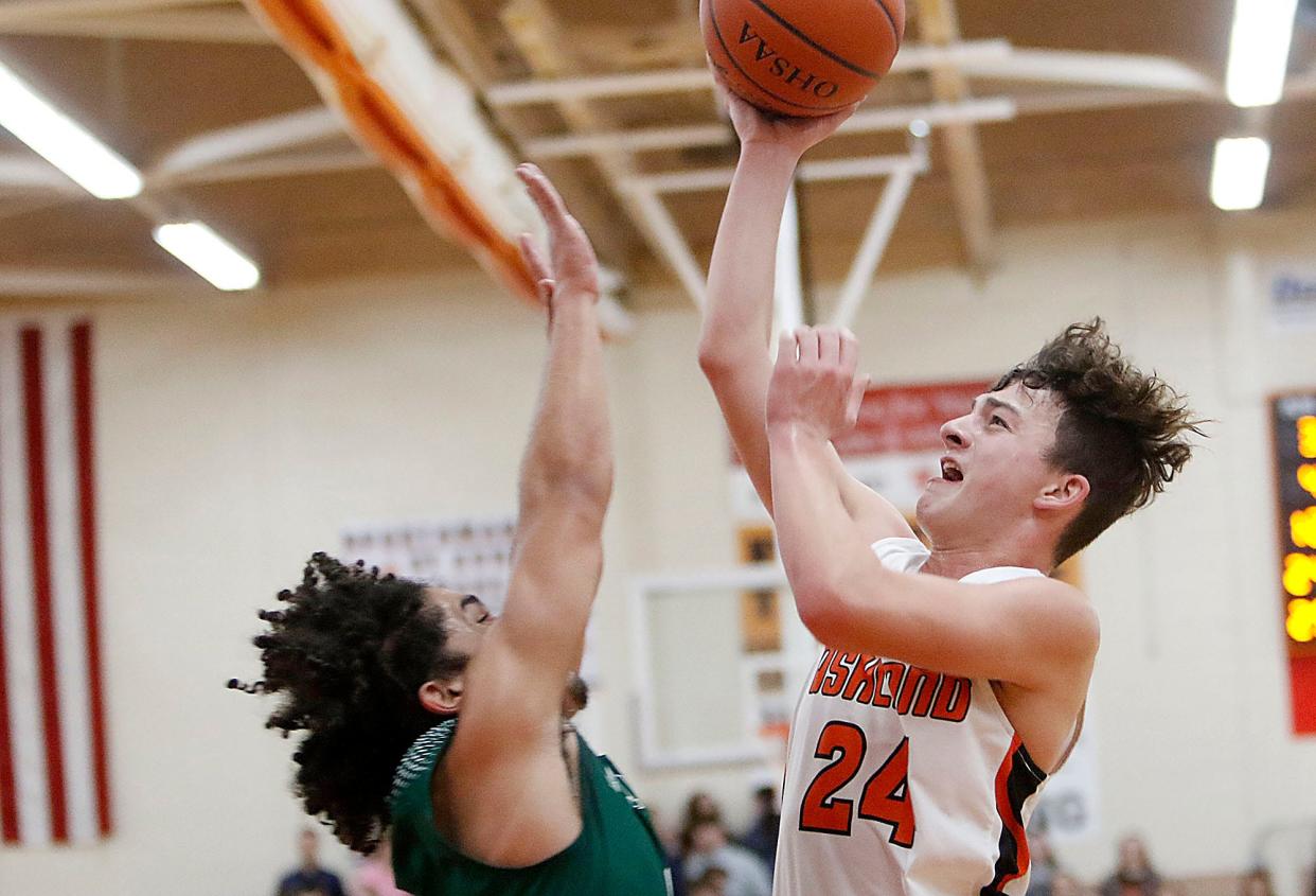 Ashland High School's Grayson Steury (24) shoots as Madison High School's Levi Zehner (4) defends during high school boys basketball action on Friday, Jan. 21, 2022 at Arrow Arena. TOM E. PUSKAR/TIMES-GAZETTE.COM