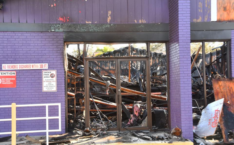 The morning after the fire at Phantom Fireworks the roof is collapsed and the parking lot littered with spent fireworks. 