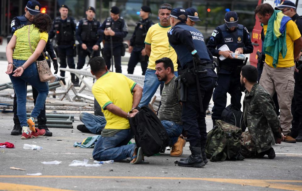 Security forces arrest supporters of Brazilian former President Jair Bolsonaro after retaking control of Planalto Presidential Palace in Brasilia on Sunday.