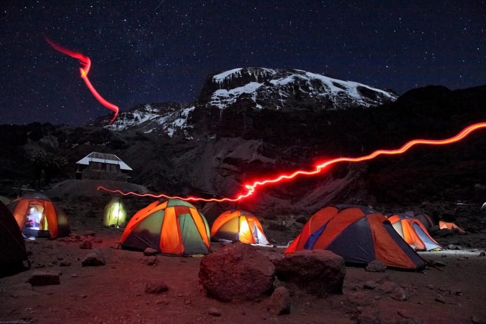 'Barranco Camp at night, Kilimanjaro.' Barranco camp was our third on our 7 day hike to the summit of Mount Kilimanjaro. Taken after dinner while the group was getting ready to get a good nights rest before tackling infamous Barracno Wall in the morning. (Photo and caption by Trevor Booth/National Geographic Traveler Photo Contest) <br> <a href="http://travel.nationalgeographic.com/travel/traveler-magazine/photo-contest/2013/" rel="nofollow noopener" target="_blank" data-ylk="slk:See more and submit;elm:context_link;itc:0;sec:content-canvas" class="link ">See more and submit</a>