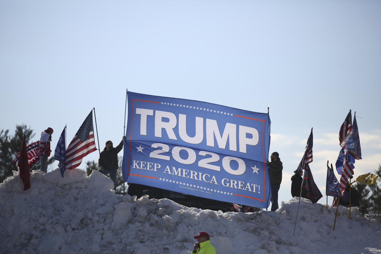 People took to a snowbank in the parking lot of Salem High School to show support for former President Donald Trump before he speaks during the New Hampshire Republican State Committee 2023 annual meeting, Saturday, Jan. 28, 2023, in Salem, N.H. (AP Photo/Reba Saldanha)