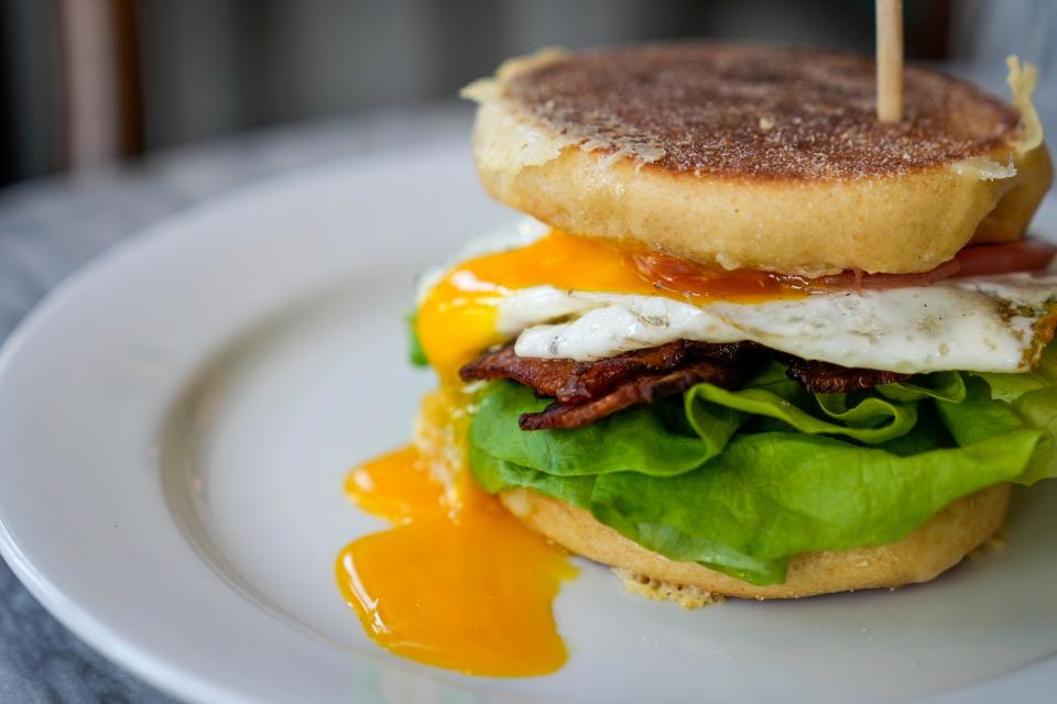 The Egg Sammy with cheddar, Calabrian aioli and pickled onion with bacon at Baker’s Table Bakery.