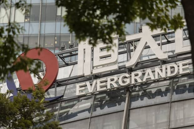 The logo of China Evergrande Group is shown on one of the company's buildings in Hong Kong. The property developer is in danger of collapsing under its debt load this week. (Qilai Shen/Bloomberg - image credit)