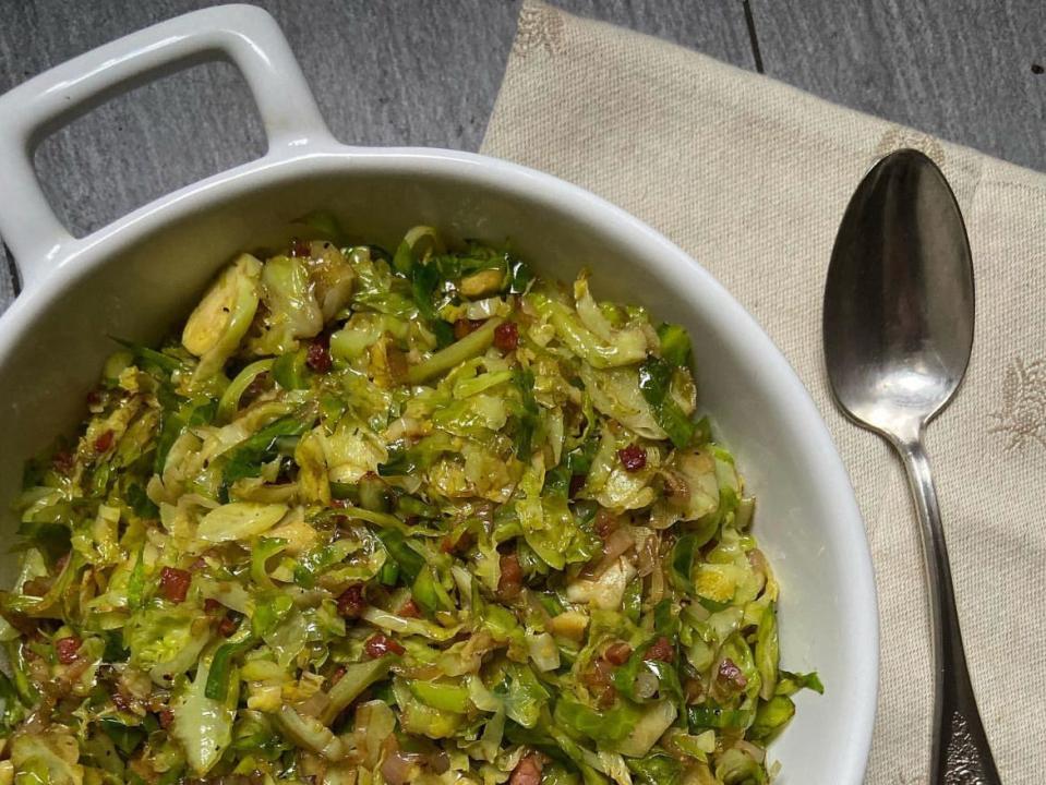 Shaved brussels sprouts in a white bowl