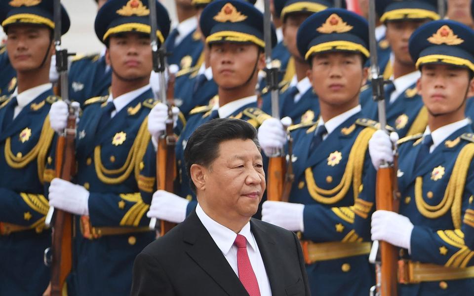 This file photo taken on July 22, 2019 Chinese President Xi Jinping (C) walking past a military honour guard during a diplomatic visit by Saudi Arabia outside the Great Hall of the People in Beijing. - Xi warned on November 11, 2021 - GREG BAKER/ AFP